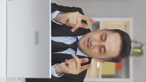 Vertical-video-of-Home-office-worker-man-attending-online-business-meeting.